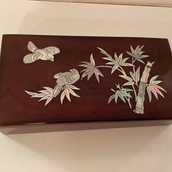 Vintage lacquered smoking box with mother of pearl inlay.
